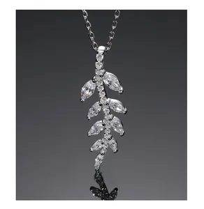 Macro shot of silver leaf pendant necklace with marquise-cut cubic zirconia and silver chain