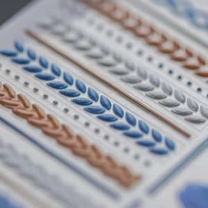 3D embossed cable knit nail art stickers with textured patterns in blue and champagne