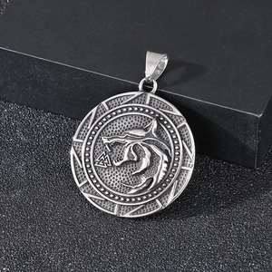 Macro detail of vintage stainless steel Viking wolf pendant with Valknut symbol engraving