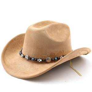 Détail de la bande ethnique avec perles bleues et breloques sur le chapeau cowboy en daim brun