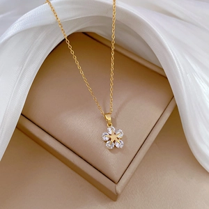Elegant gold star pendant necklace with cubic zirconia on a luxury jewelry box