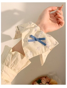 Detail of floral scrunchie with rabbit print, blue bow, and Hand Made label