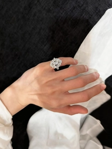 Close-up of a luxury zircon oval ring with a sunburst design on a model's hand
