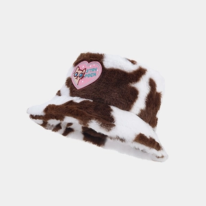 Detailed view of plush cow print bucket hat with pink heart cat embroidery patch