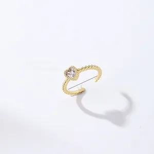 Detail of beaded gold ring featuring heart zircon stone with 1.8cm diameter specifications