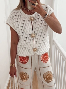 White boho crochet top with sun buttons and matching embroidered wide-leg pants