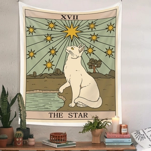 Detail of The Star cat tarot tapestry on a white wall with houseplants and home decor