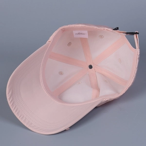Internal view of the pink baseball cap featuring a six-panel structure and adjustable buckle