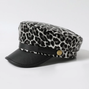 Chic leopard print beret with black leather brim and golden buckle detail in main view