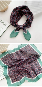 Detail of vintage floral cotton linen scarf with navy blue base and green border