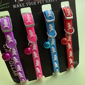 Set of four colorful silicone cat collars with fish bone patterns and matching bells