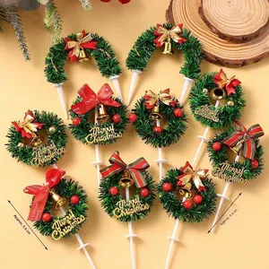 Miniature Christmas wreath decorations with red bows and gold Merry Christmas signage