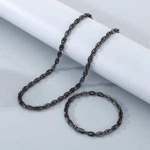 Detail of black plated pig nose anchor chain necklace and bracelet set on props