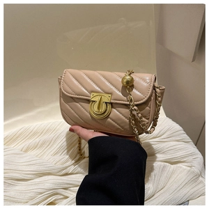 Detailed shot of beige V-quilted small square bag with golden chain and adjustable ball