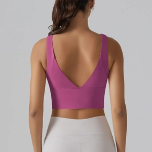 Detail view of deep magenta sports bra featuring a V-shaped open back and elastic support band