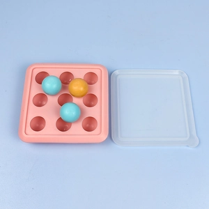 Detailed view of pink silicone mold with 9 spherical cavities and clear plastic cover