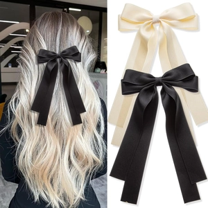 Dual-layer large bow hair clip with long ribbons in black and cream satin finish