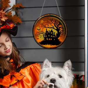 Halloween hanging ornament featuring spooky haunted house over moon with metal chain