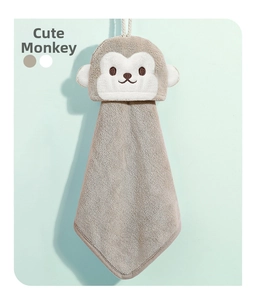Detail of hanging grey coral fleece hand towel with cute cartoon monkey embroidery