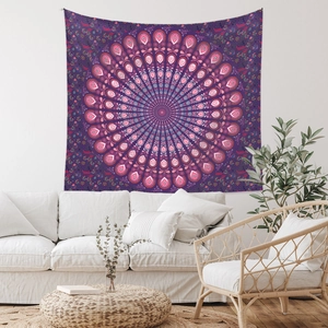 Detail view of purple Bohemian mandala tapestry hung over a white sofa in a modern room