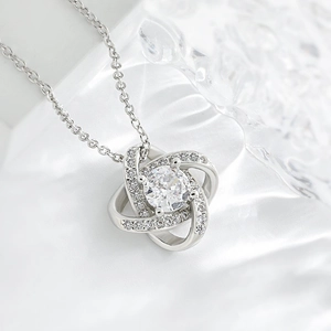 Close-up detail of silver interlocking loop cubic zirconia pendant necklace showcasing sparkles.
