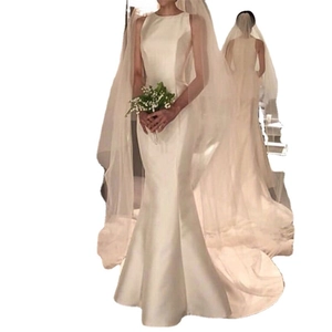 Minimalist ivory satin mermaid wedding dress with sleeveless neckline and long bridal veil