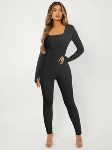 Detail of square neck yoga jumpsuit with thumbhole cuffs and ribbed knit texture