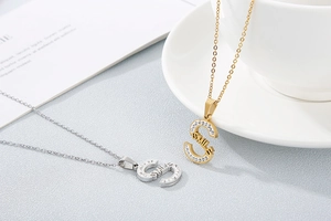 Detailed view of Smile necklaces in gold and silver finish with sparkling rhinestones