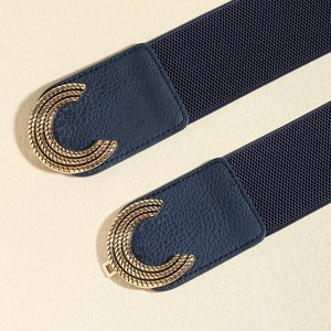 Detail of blue elastic waist belt with golden textured C-shape buckle and faux leather finish