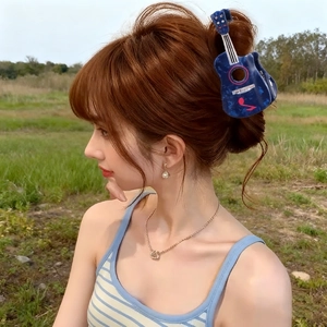 Blue guitar shaped hair claw clip with rhinestones for music festival hair styling