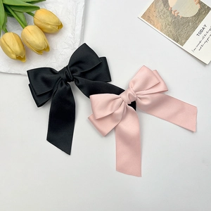 Elegant satin bow hair clips in black and pink with long ribbons for women