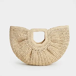 Minimalist ivory straw crescent beach bag with integrated round handle for vacation