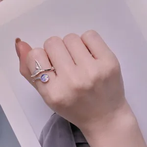 Elegant S925 sterling silver mermaid tail ring with iridescent stone on a female hand