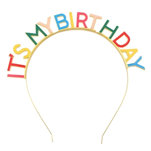 Detail of colorful enamel drip lettering IT'S MY BIRTHDAY on a gold party headband