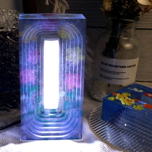 Illuminated trapezoid resin night light with dried flowers and blue glitter sparkles