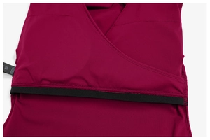 Detail view of deep burgundy V-neck stitching and internal black elastic support band