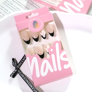 Almond fake nails with black French tips and 3D white flowers in a pink gift box