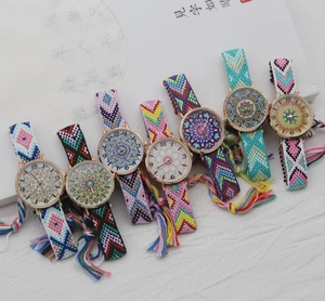 Flat lay of colorful Bohemian woven strap watches with ethnic patterns and tassels