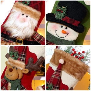 Detailed view of plush 3D Santa, Snowman and Reindeer embroidery on Christmas stockings