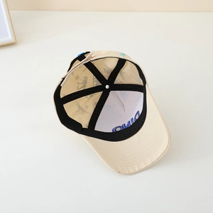 Inside view of beige cotton kids dinosaur baseball cap with blue DINO embroidery