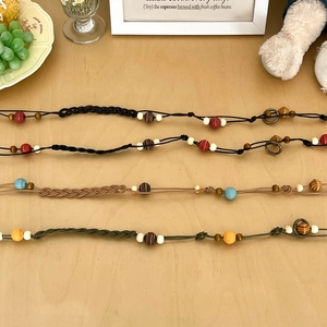 Detail of bohemian woven bead waist chains showing diverse textures and colorful beads