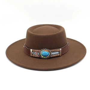 Close-up of bohemian felt hat featuring a leather band with turquoise buckle detail