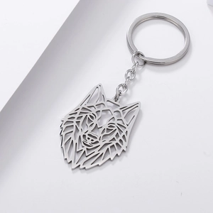 Close-up of silver hollow geometric wolf head keychain with intricate cut-out details