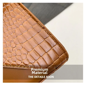 Detailed macro shot of premium brown leather with elegant crocodile embossed texture