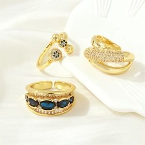 Detailed view of three 18K gold plated rings with blue and clear zircon gemstones