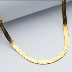 Detailed close-up of 18k gold-plated snake chain necklace showing metallic texture