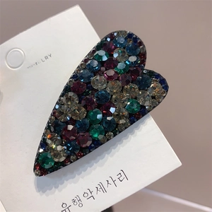 Close-up of heart-shaped BB clip with vibrant multi-colored Czech rhinestones