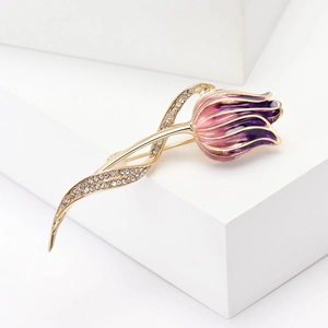 Macro detail of tulip brooch with pink enamel petals and sparkling rhinestone stem