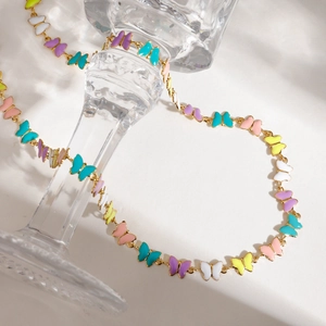 Polished stainless steel butterfly necklace with colorful enamel charms on glass