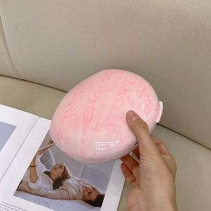 Pink marble pattern evening clutch bag with oval shape and minimalist gradient design